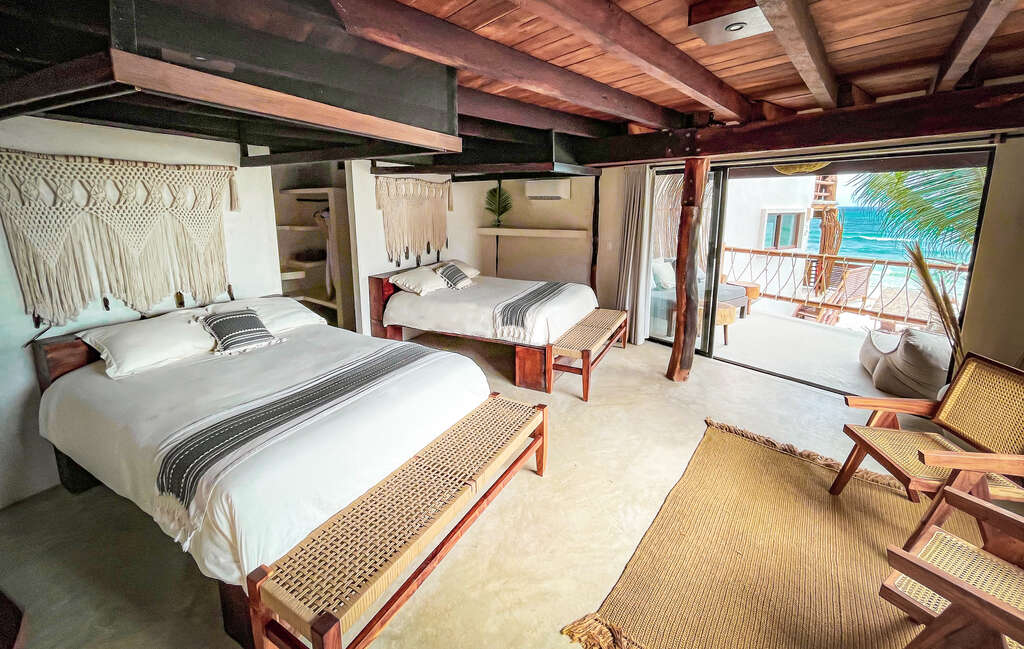 A large room with two queen beds and nice views of the ocean. These rooms have a large terrace and a lot of natural light.