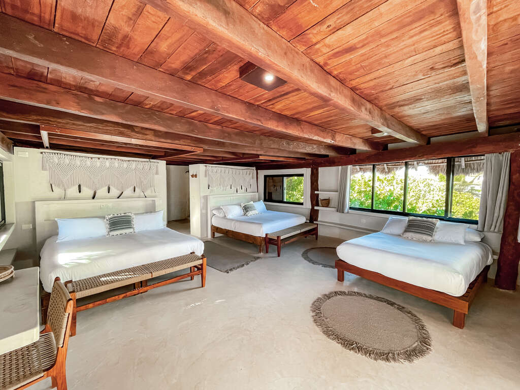 A large room set up to share. Each person has their own little space while sharing a large room with 2 other yogis. Rooms do not have a beach view and are slightly back in the property, but are comfortable and beautiful.